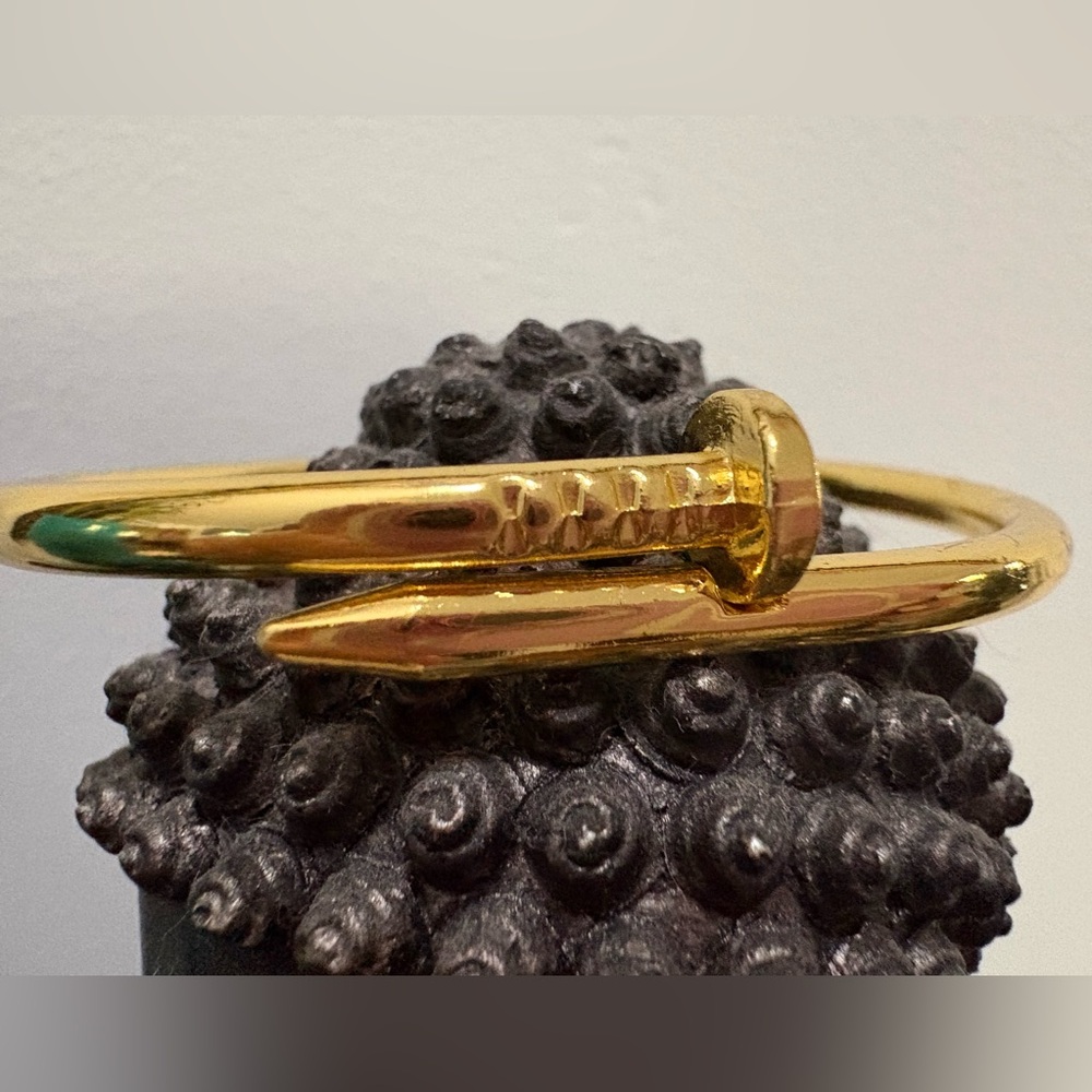 Gold tone stainless steel nail style bangle 7.5”